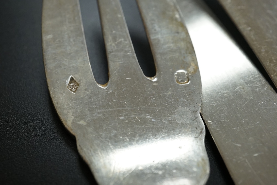 Eighteen pairs of early 20th century French 950 standard white metal fish eaters by Olier & Caron, together with a set of twelve French silver dessert knives(loaded handles) a French white metal table fork and two French